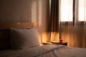 cozy bedroom with dim lights and comfortable bed for better sleep naturally